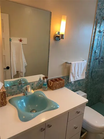 a living room with furniture and a view of kitchen