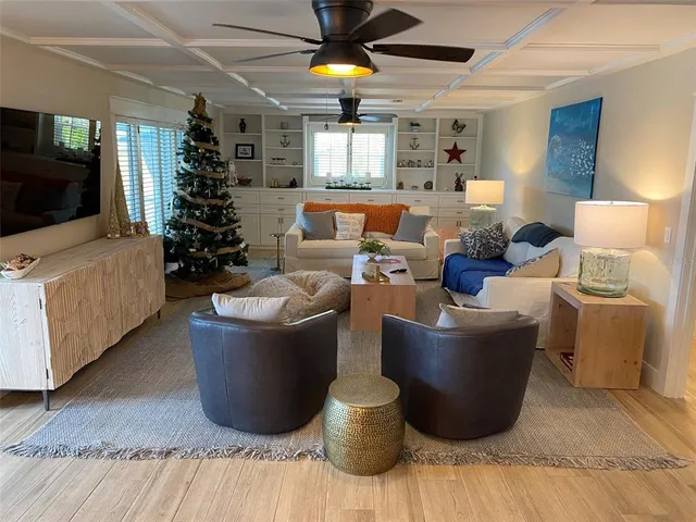 a kitchen with kitchen island granite countertop a stove a sink and a microwave