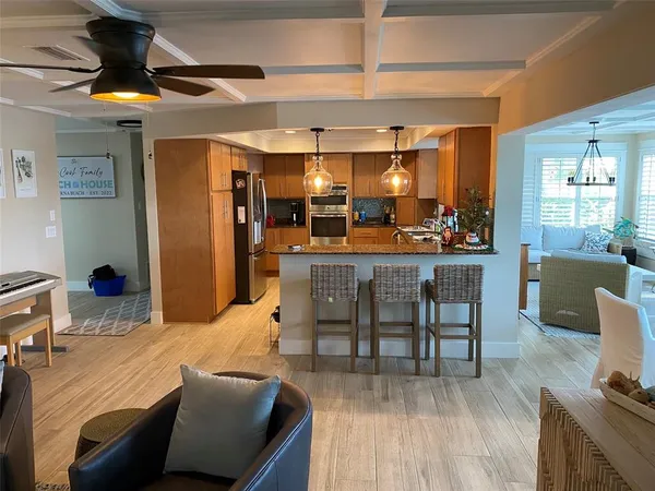 a view of a hallway with wooden floor and a window