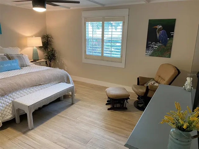 a dining room with furniture a chandelier and wooden floor