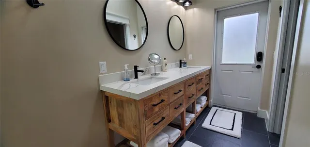 a living room with furniture a chandelier and a dining table