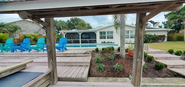 a bedroom with a bed a mirror and lamp on dresser