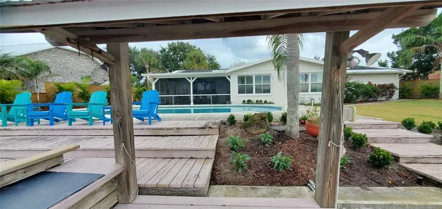 a bedroom with a bed a mirror and lamp on dresser