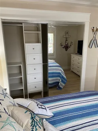 a bedroom with bed and a window