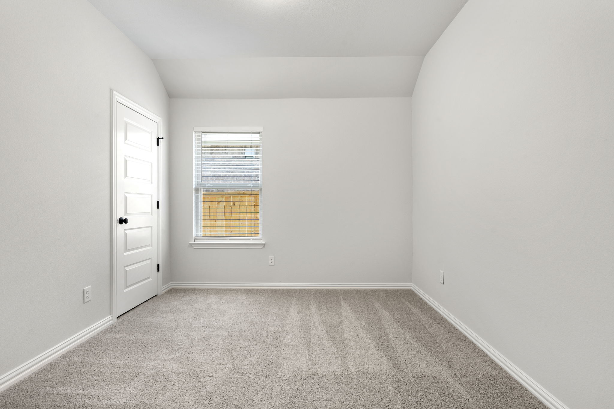 341 Fawn Riv Run Kyle, TX 78640 - Photo 21 of 29 Carpeted empty room featuring baseboards and vaulted ceiling
