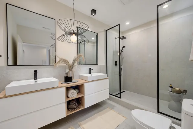 a bathroom with a sink a toilet and shower