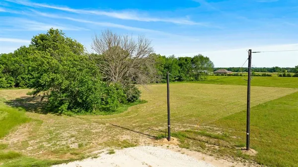a view of a field with an ocean view