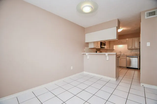 a kitchen with a sink a stove and cabinets