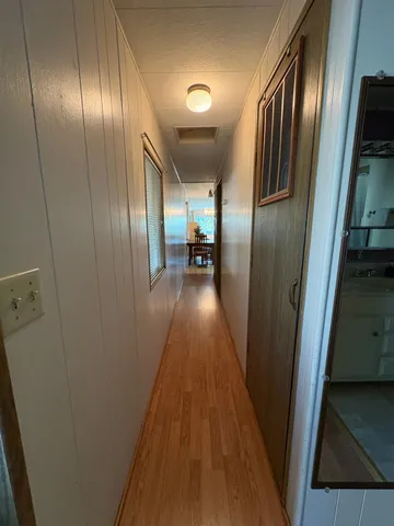 a view of gallery with wooden floor