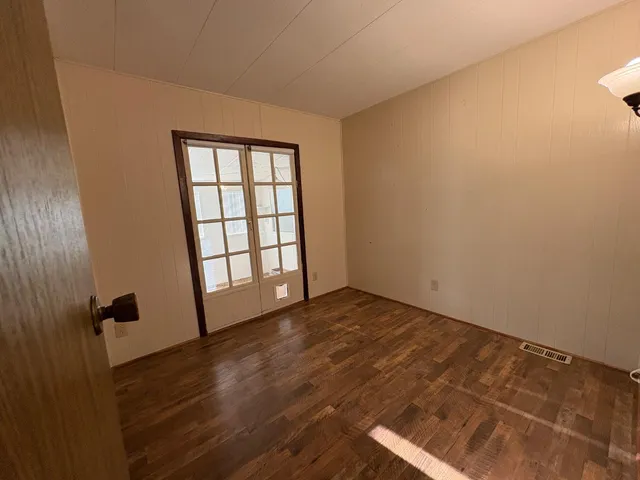 a view of front door with wooden floor