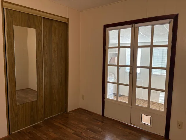 a view of a porch with chairs and potted plants
