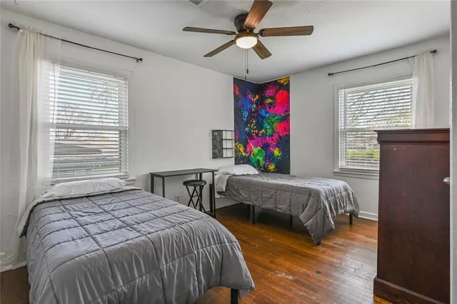 a bedroom with a bed and windows