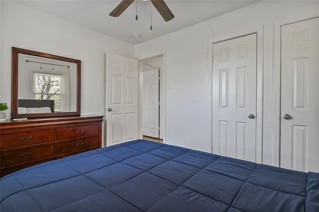 a bedroom with a bed and a large mirror