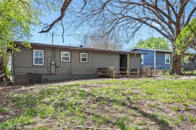 a backyard of a house with barbeque oven