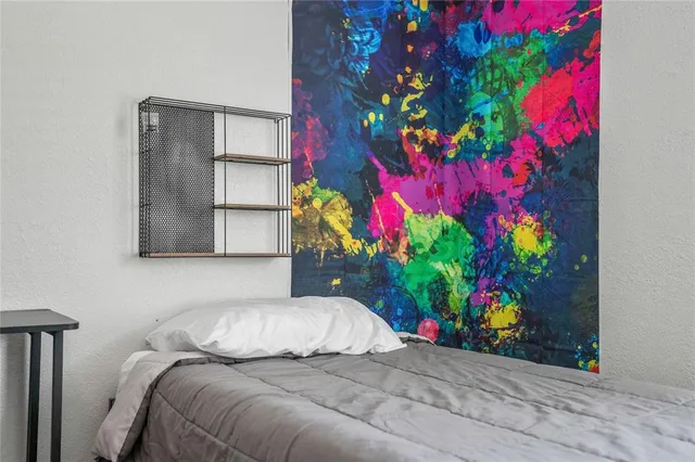 a bedroom with a bed and a potted plant