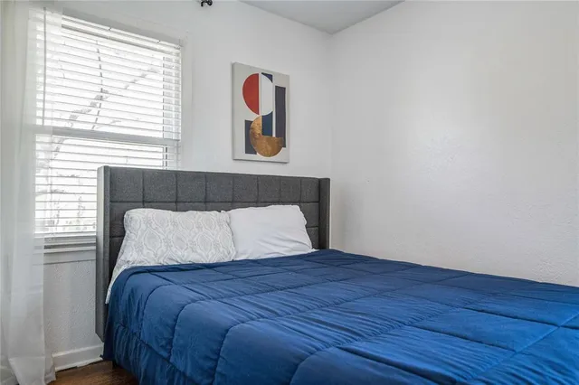 a bedroom with a bed and a window