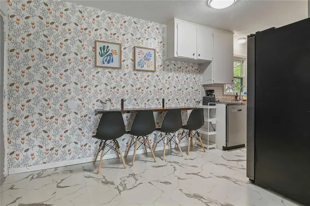 a kitchen with a table and chairs