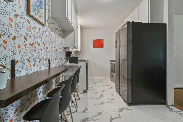 a hall with a stove and a refrigerator