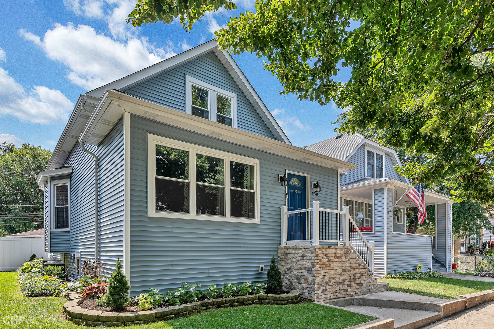 4841 West Berenice Avenue Chicago, IL 60641 - Photo 1 of 34 a front view of a house with a garden