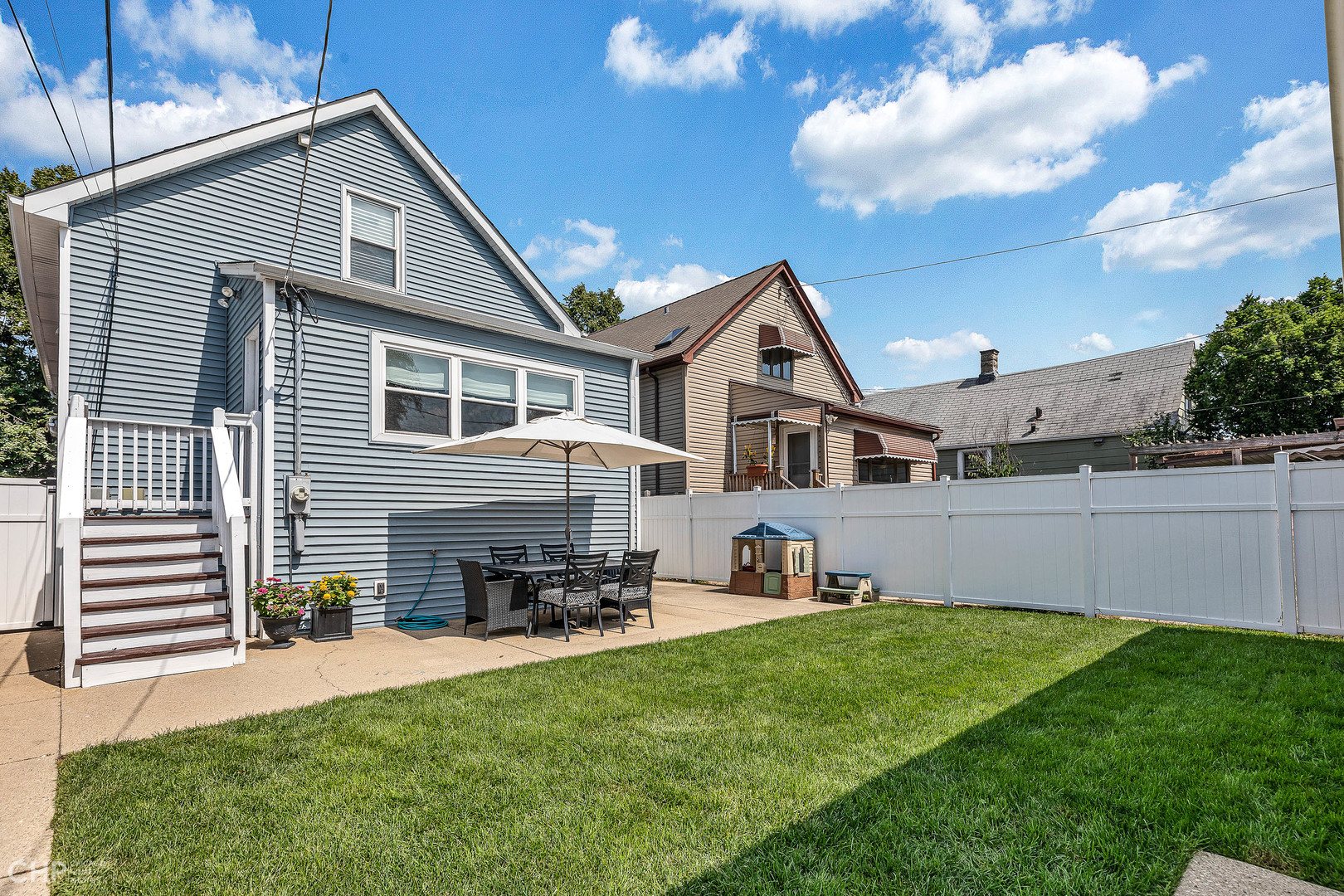 4841 West Berenice Avenue Chicago, IL 60641 - Photo 16 of 34 a front view of a house with a garden and chairs