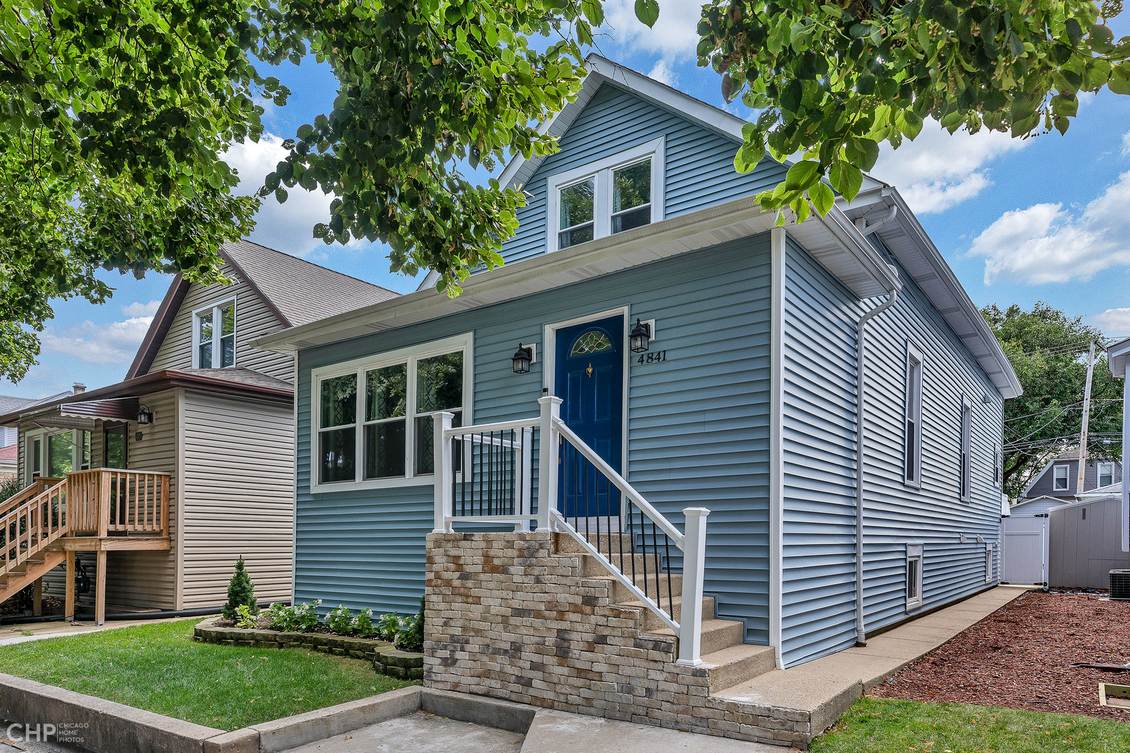 4841 West Berenice Avenue Chicago, IL 60641 - Photo 2 of 34 a front view of a house with a garden