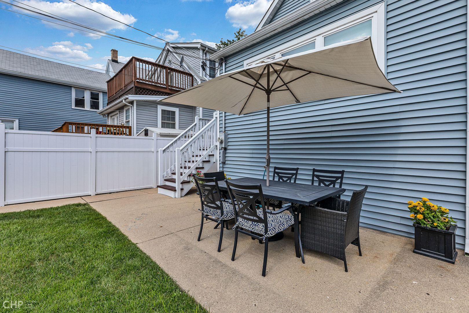 4841 West Berenice Avenue Chicago, IL 60641 - Photo 21 of 34 a view of a patio with table and chairs and a barbeque