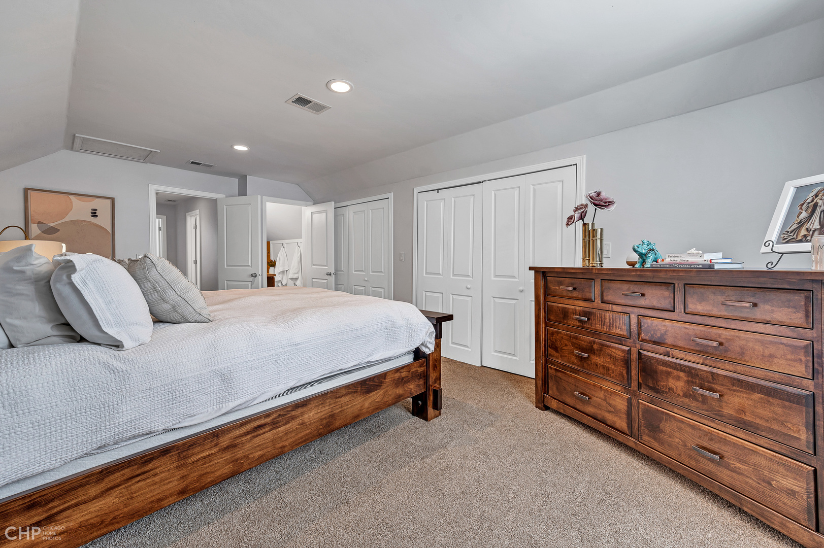 4841 West Berenice Avenue Chicago, IL 60641 - Photo 23 of 34 a spacious bedroom with a bed and a dresser