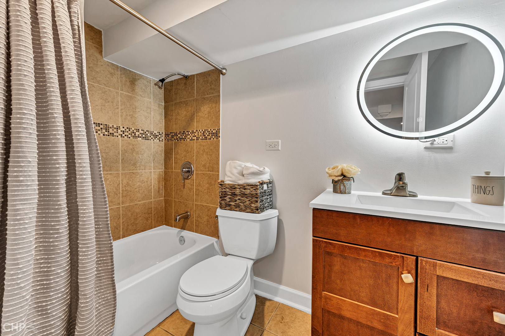 4841 West Berenice Avenue Chicago, IL 60641 - Photo 29 of 34 a bathroom with a sink a mirror a toilet and a shower