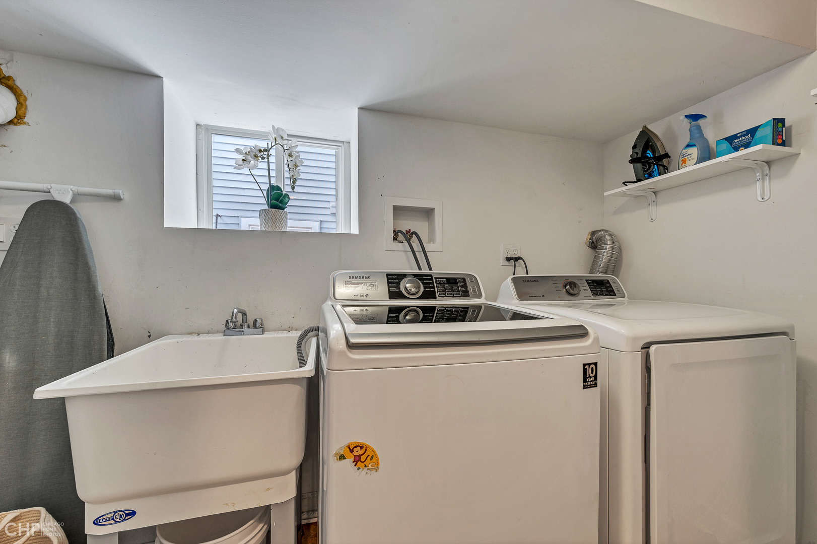 4841 West Berenice Avenue Chicago, IL 60641 - Photo 30 of 34 a kitchen with a sink a stove and white cabinets