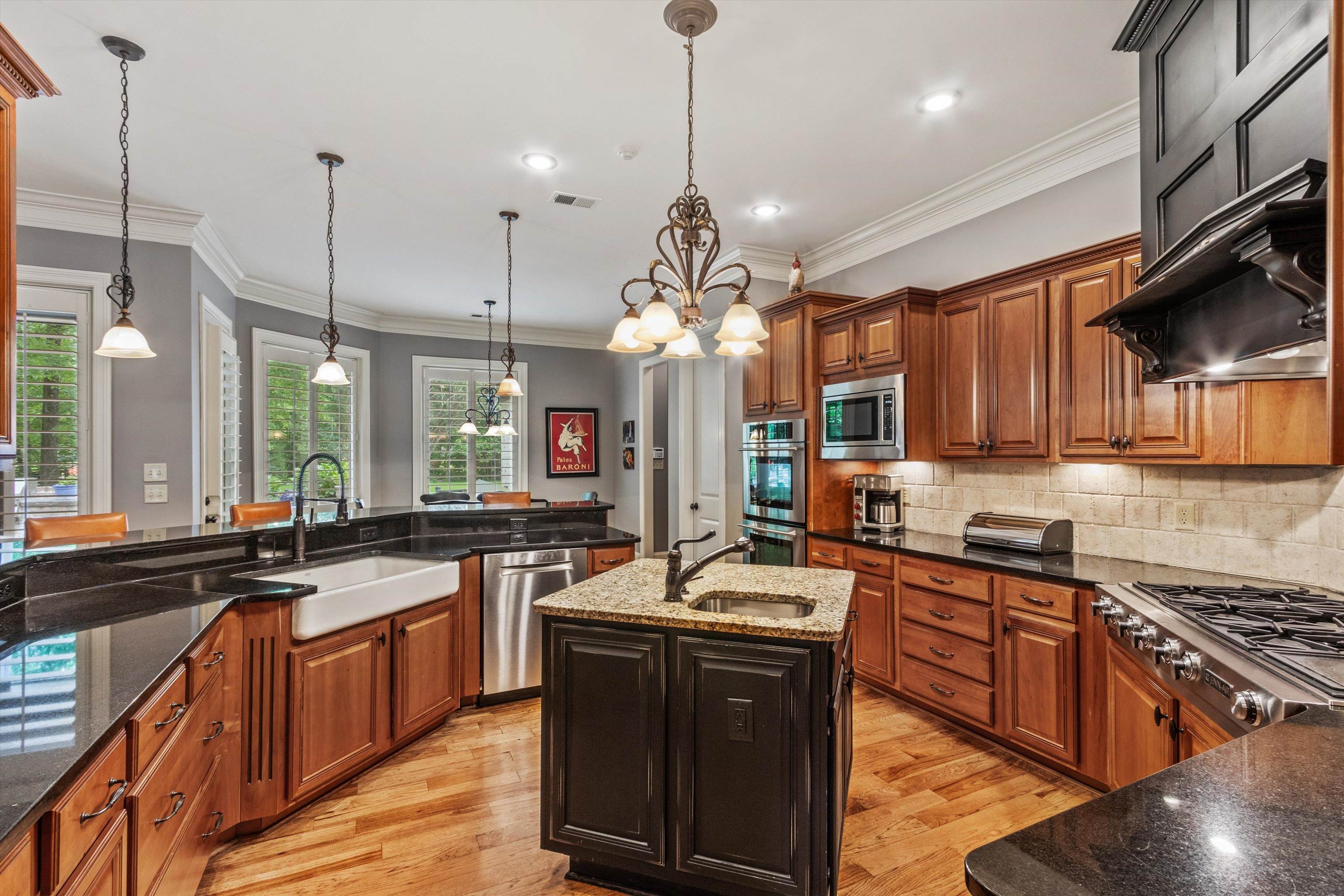 150 Ridgecrest Drive Arlington, TN 38002 - Photo 15 of 40 Kitchen featuring warm-toned cabinetry, dark countertops, and wood-finish flooring