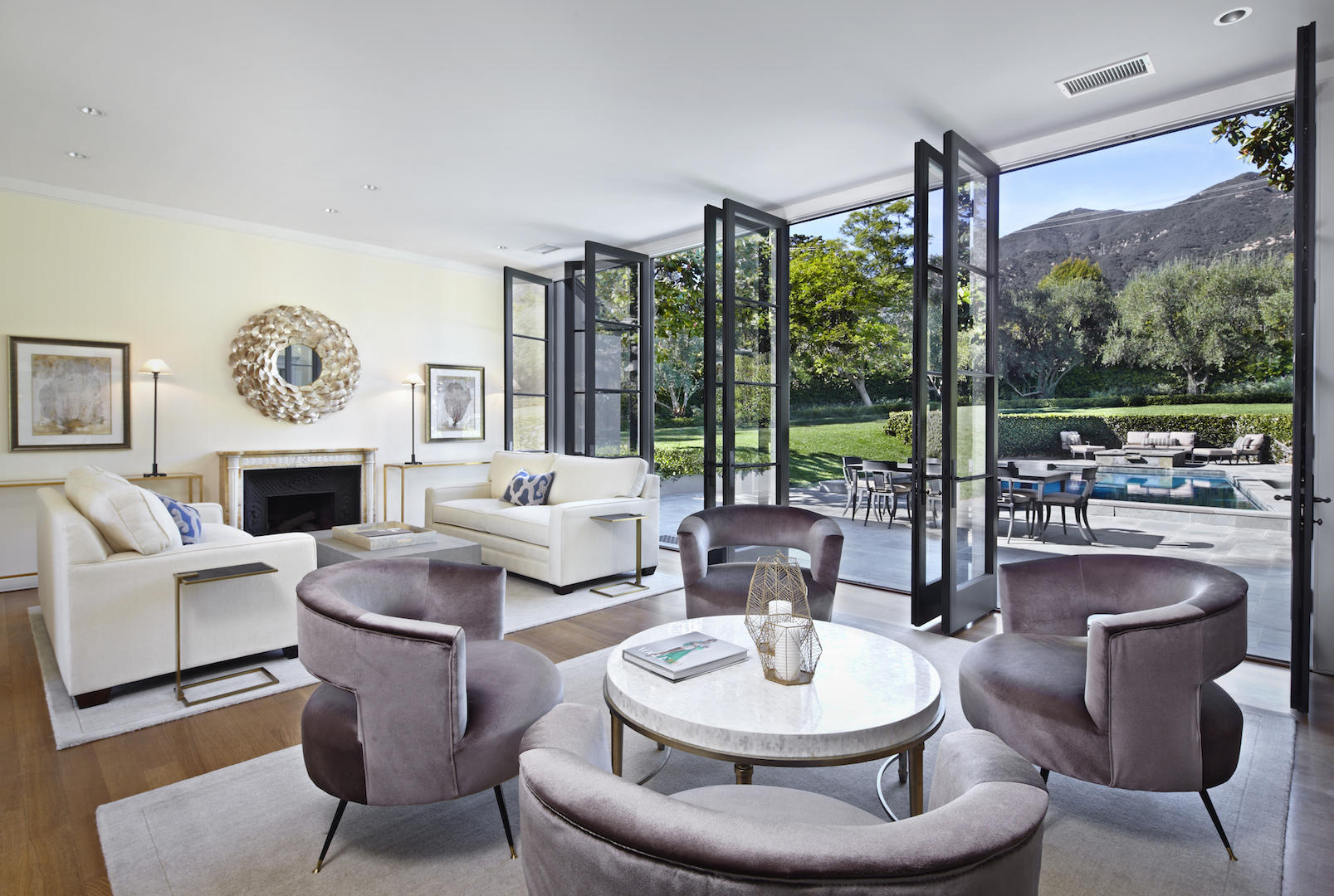 760 San Ysidro Road Santa Barbara, CA 93108 - Photo 3 of 12 a living room with furniture a large window and a fireplace