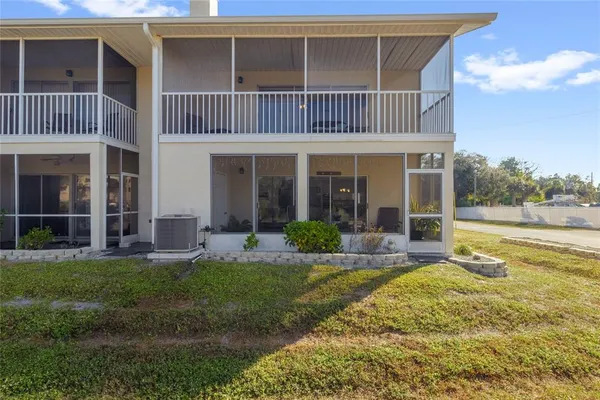 a view of a house with a yard and sitting area