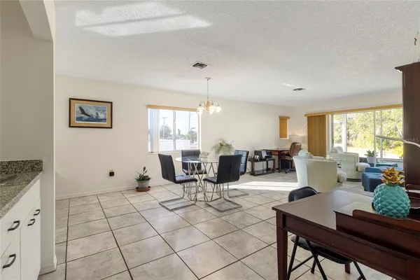 a living room with furniture a window and a table