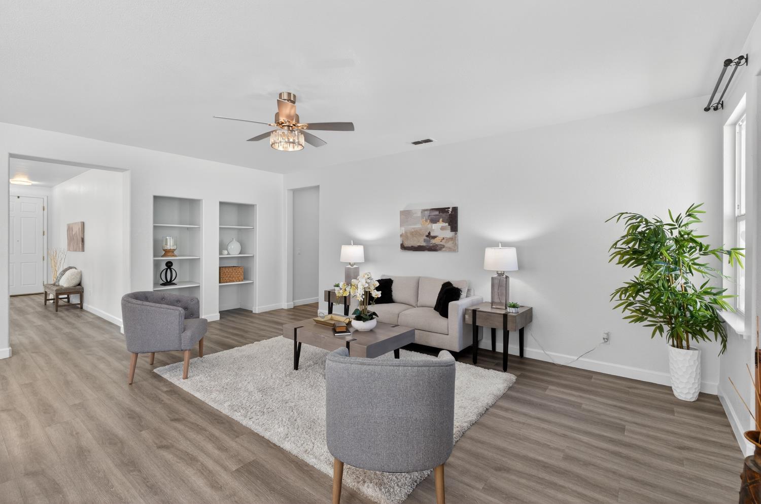 6217 Jefjen Way Elk Grove, CA 95757 - Photo 11 of 58 a living room with furniture potted plant and a chandelier