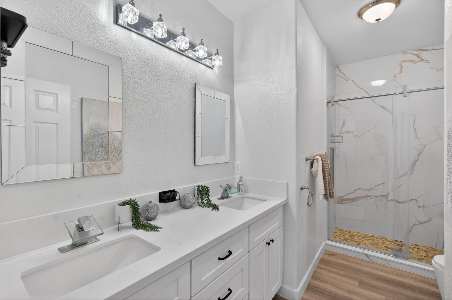6217 Jefjen Way Elk Grove, CA 95757 - Photo 26 of 58 a bathroom with double vanity sink and a mirror