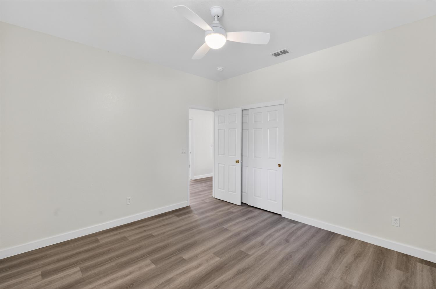 6217 Jefjen Way Elk Grove, CA 95757 - Photo 31 of 58 a view of an empty room with wooden floor