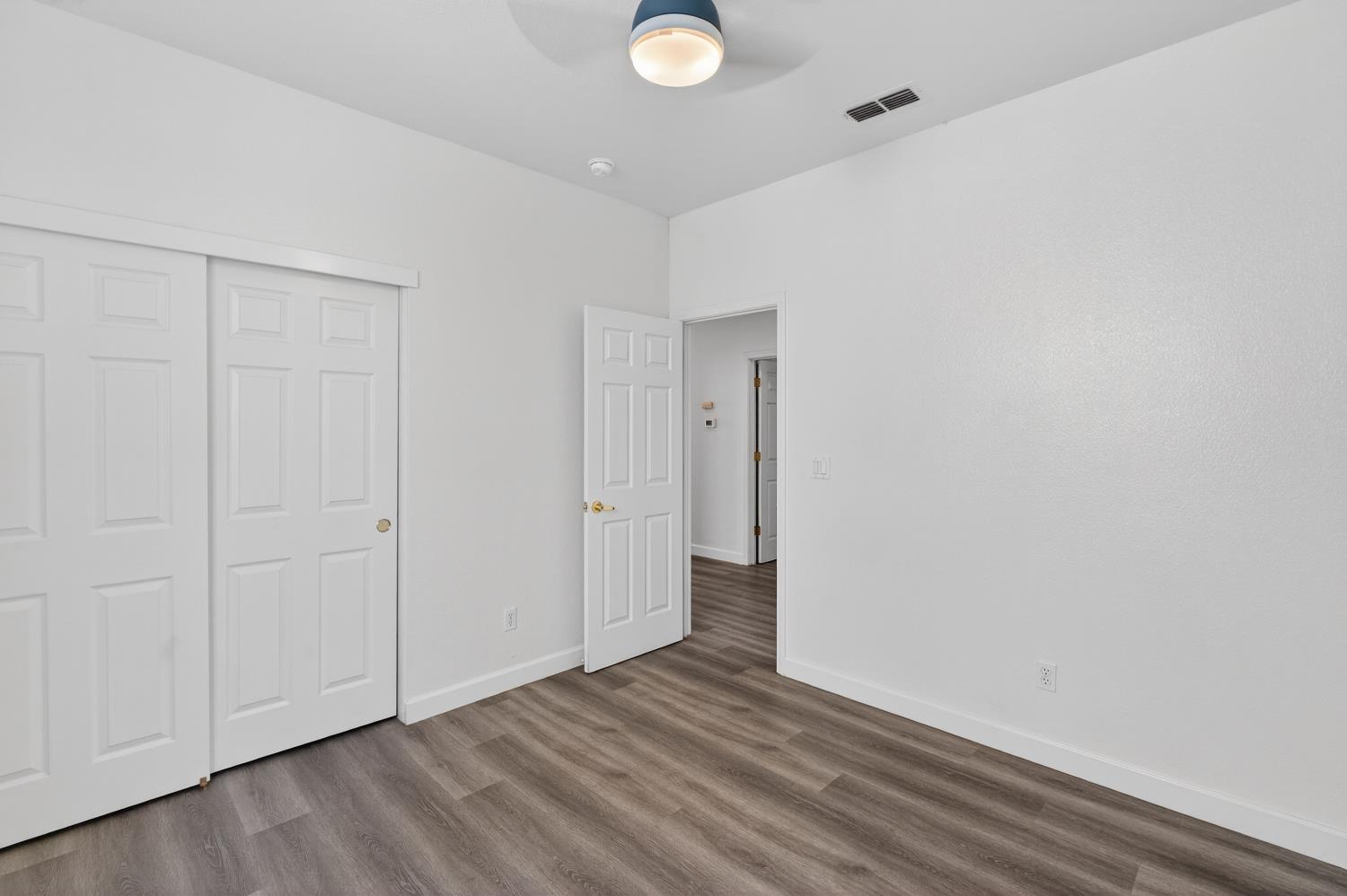6217 Jefjen Way Elk Grove, CA 95757 - Photo 33 of 58 a view of an empty room with wooden floor