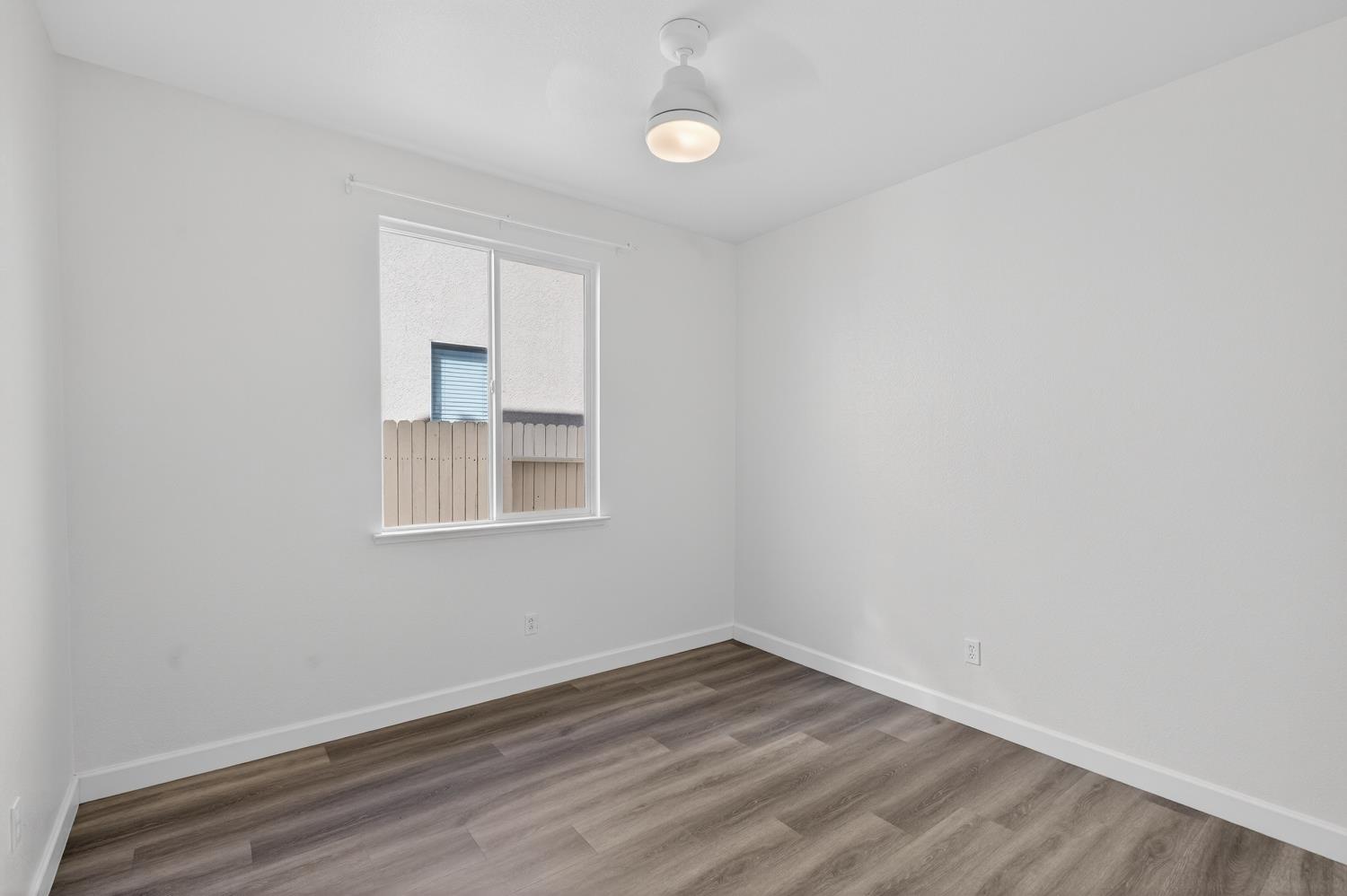 6217 Jefjen Way Elk Grove, CA 95757 - Photo 34 of 58 a view of an empty room with wooden floor and a window