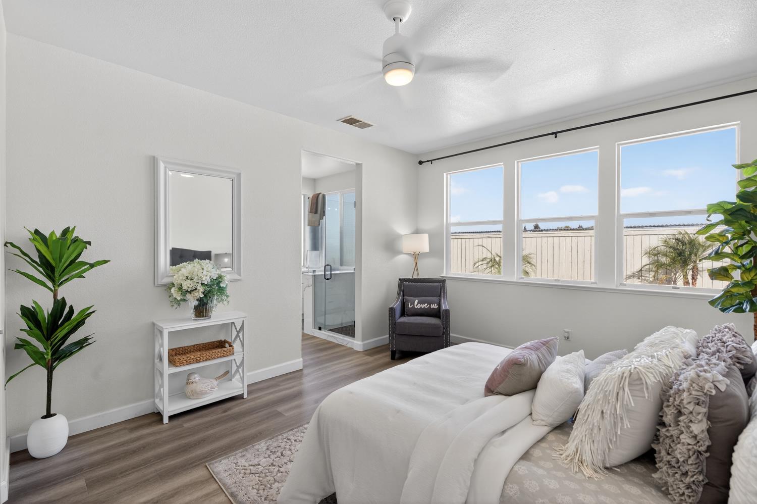 6217 Jefjen Way Elk Grove, CA 95757 - Photo 38 of 58 a bedroom with a large bed and a potted plant