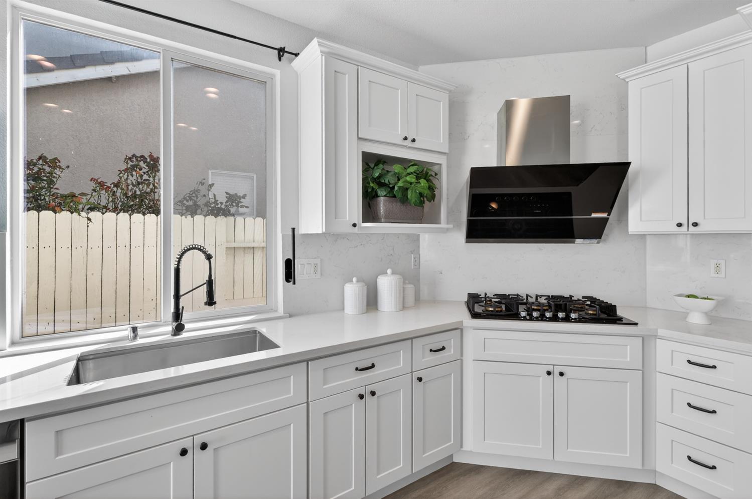 6217 Jefjen Way Elk Grove, CA 95757 - Photo 4 of 58 a kitchen with white cabinets a sink and a window
