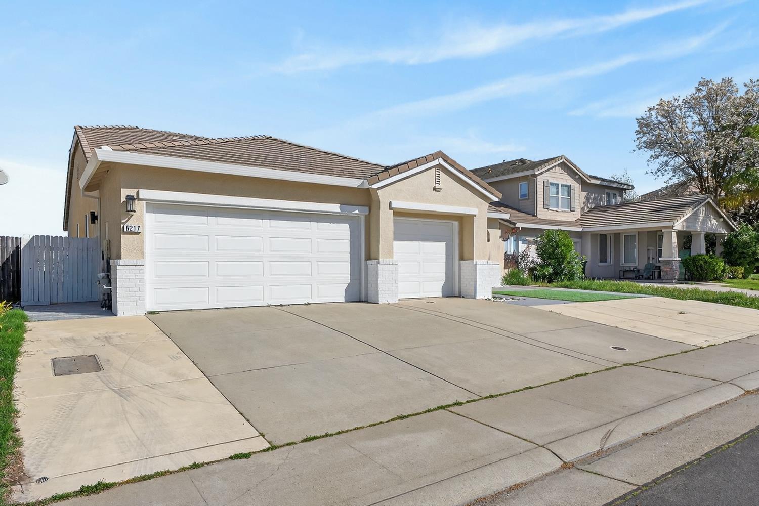 6217 Jefjen Way Elk Grove, CA 95757 - Photo 8 of 58 a front view of a house with a yard and garage