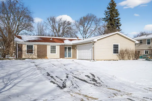 a view of a house with a yard covered in snow
