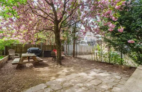 a view of a backyard with sitting area