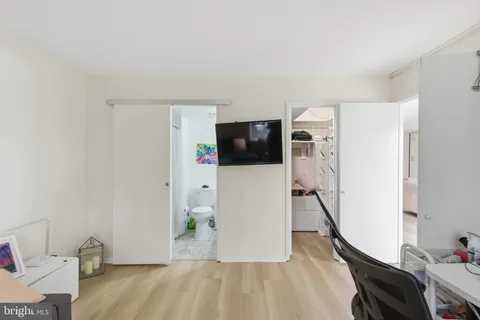 a view of a livingroom with wooden floor and stairs