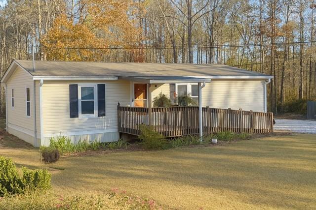 a front view of a house with a yard and outdoor seating