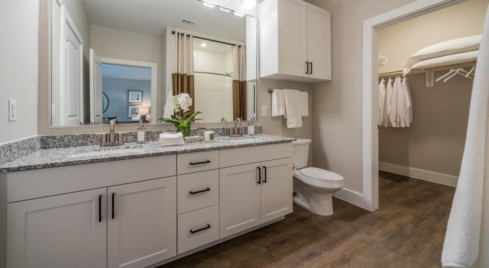 4647 Harvest Corner Drive, Unit 1114 Richmond, TX 77406 - Photo 13 of 34 a bathroom with a granite countertop sink toilet and mirror