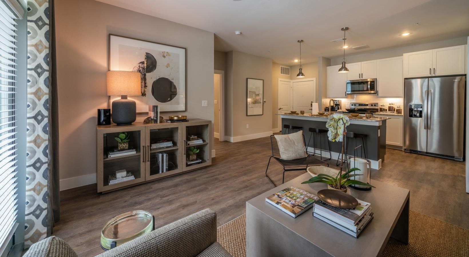 4647 Harvest Corner Drive, Unit 1114 Richmond, TX 77406 - Photo 4 of 34 a living room with stainless steel appliances furniture a rug and a kitchen view