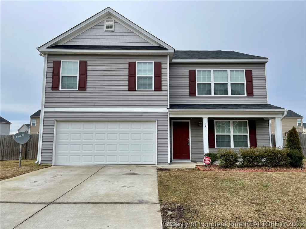 251 Botanical Court Bunnlevel, NC 28323 - Photo 1 of 16 a front view of a house with a yard and garage