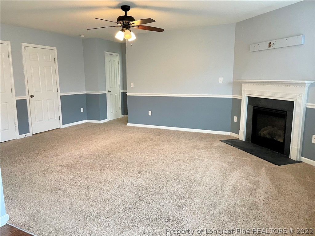 251 Botanical Court Bunnlevel, NC 28323 - Photo 11 of 16 a view of a livingroom with a ceiling fan fireplace and a window