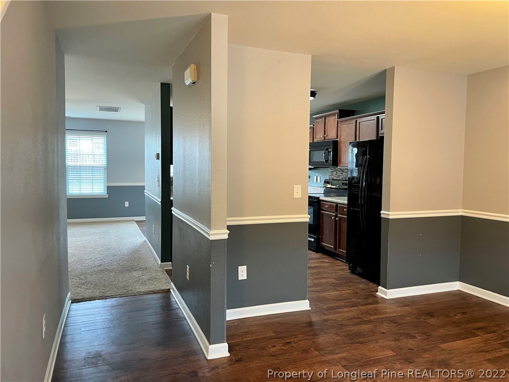251 Botanical Court Bunnlevel, NC 28323 - Photo 12 of 16 a view of a kitchen with a refrigerator and a stove top oven